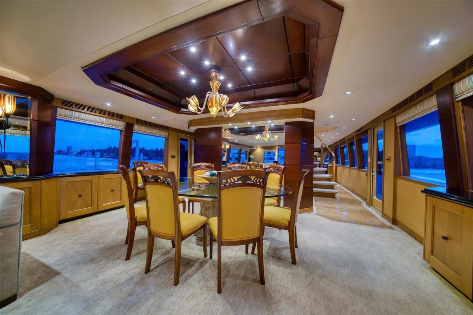 a room with a table chairs and a tv aboard NORTH COAST 120 Yacht for Sale