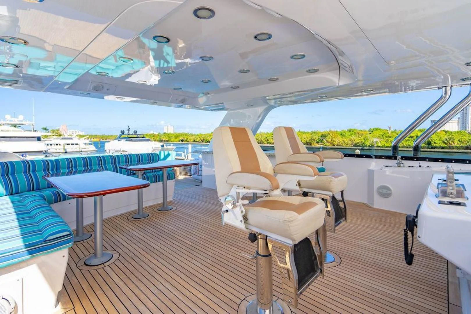 a room with a table and chairs aboard NORTH COAST 120 Yacht for Sale
