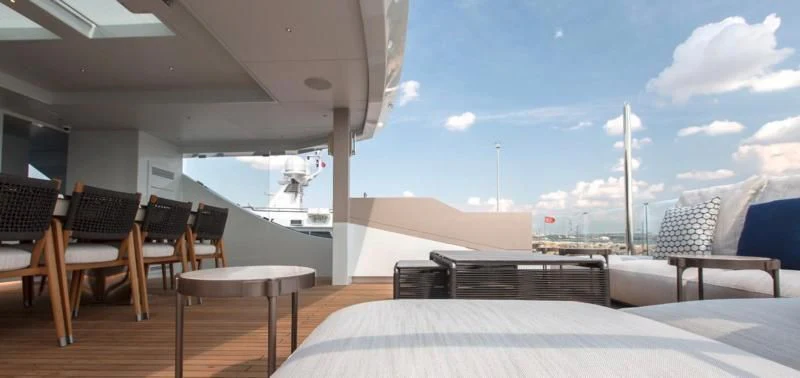 a room with a bed and chairs aboard CROCUS Yacht for Sale