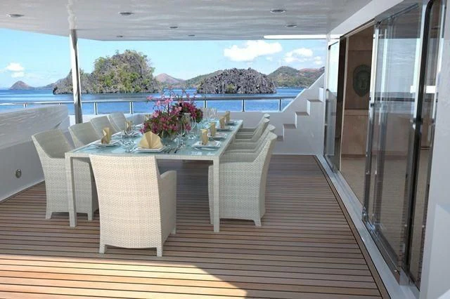 a table set for a meal on a deck aboard CROCUS Yacht for Sale