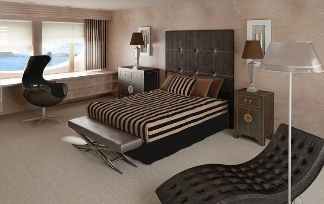 a bedroom with a bed and a chair aboard CROCUS Yacht for Sale