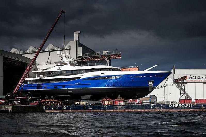 a large blue and white boat aboard NOMAD Yacht for Sale