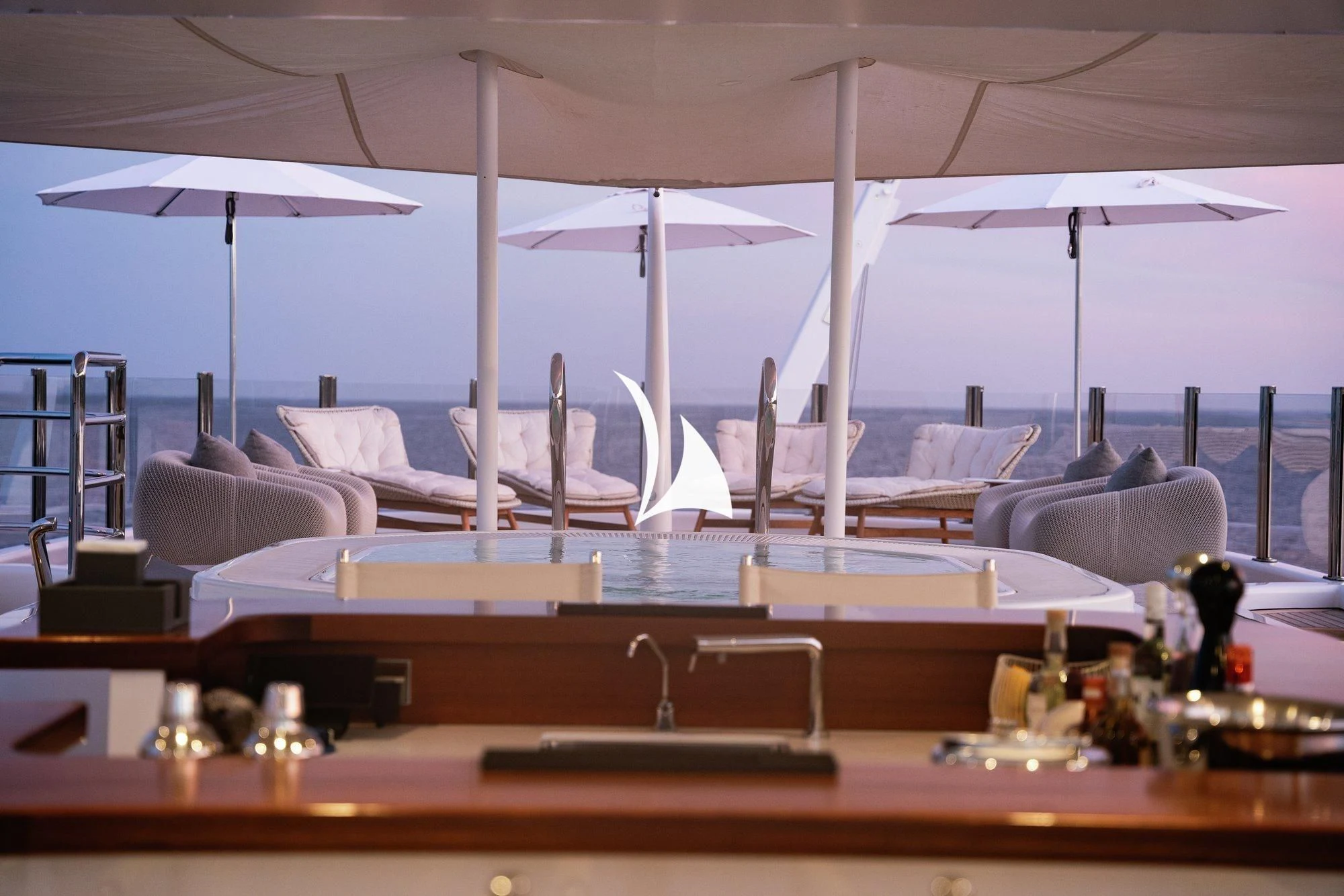 a room with many white umbrellas aboard NOMAD Yacht for Sale