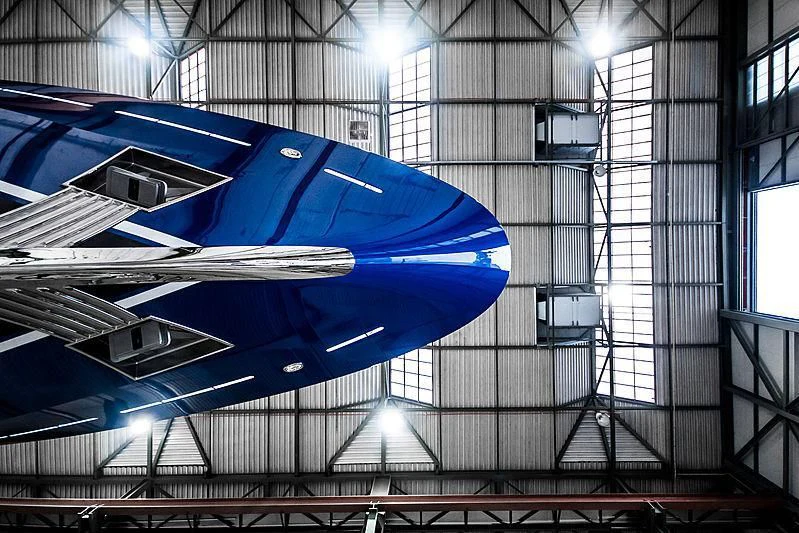 a large blue airplane in a warehouse aboard NOMAD Yacht for Sale