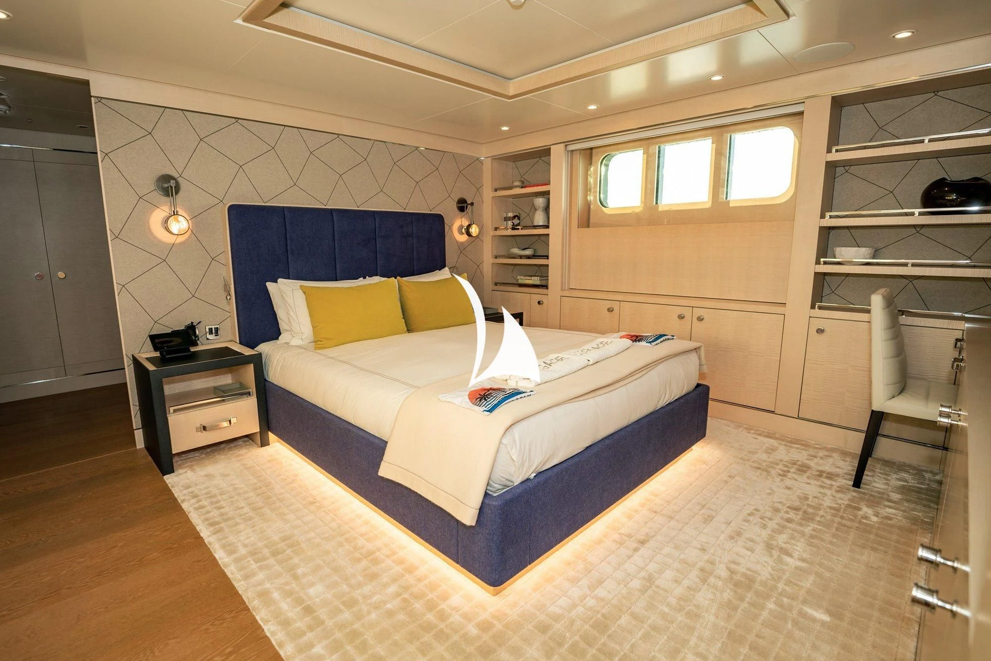 a bedroom with a bed and a desk aboard NOMAD Yacht for Sale