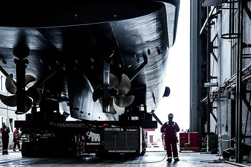 a man standing in front of a large machine aboard NOMAD Yacht for Sale