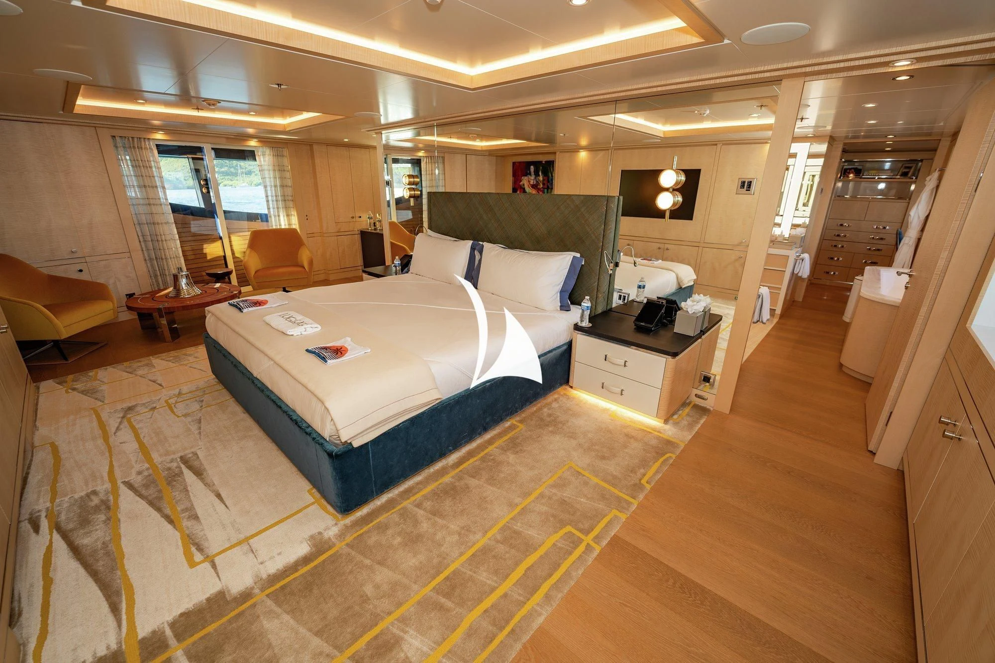 a bedroom with a bed and a couch aboard NOMAD Yacht for Sale
