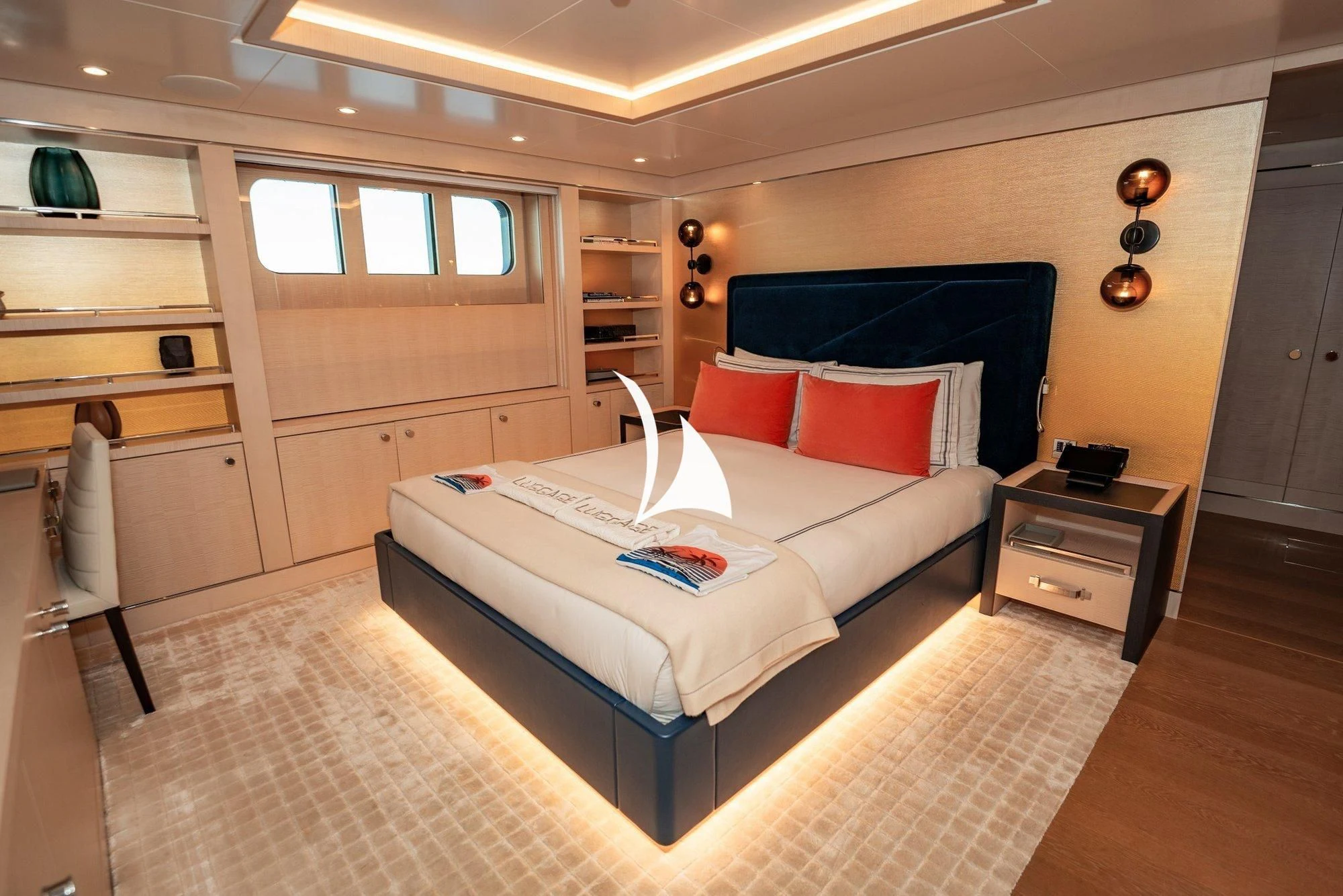 a bedroom with a bed and a desk aboard NOMAD Yacht for Sale