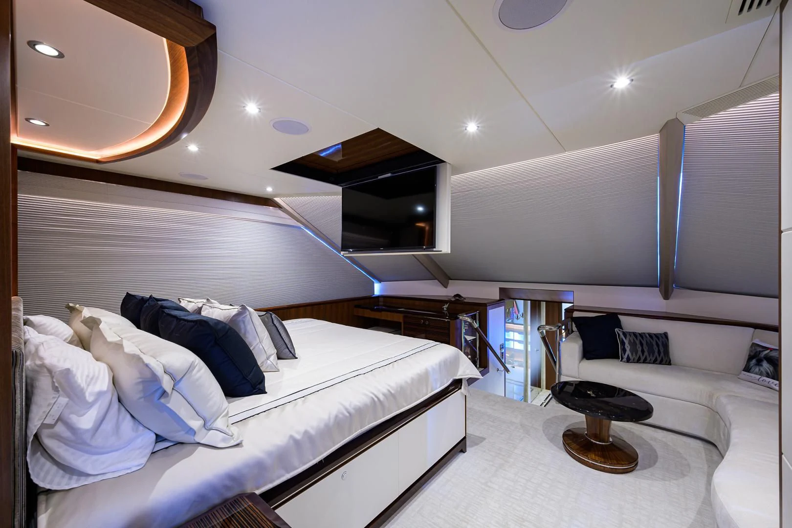 a room with a bed and a desk aboard ZEPHYR Yacht for Charter