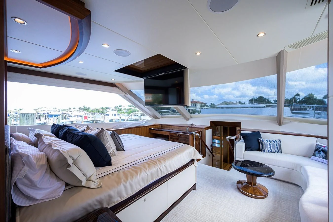 a room with a bed and a large window aboard ZEPHYR Yacht for Charter
