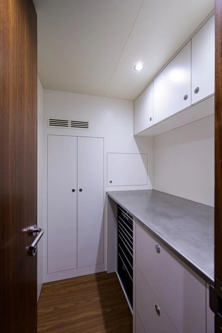 a kitchen with white cabinets aboard ZEPHYR Yacht for Charter
