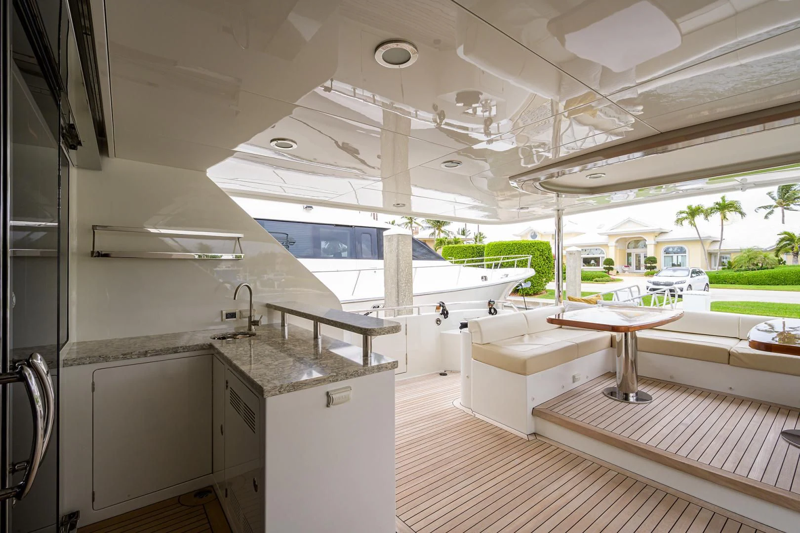 a kitchen with a large white sink and a large white boat in the background aboard ZEPHYR Yacht for Charter