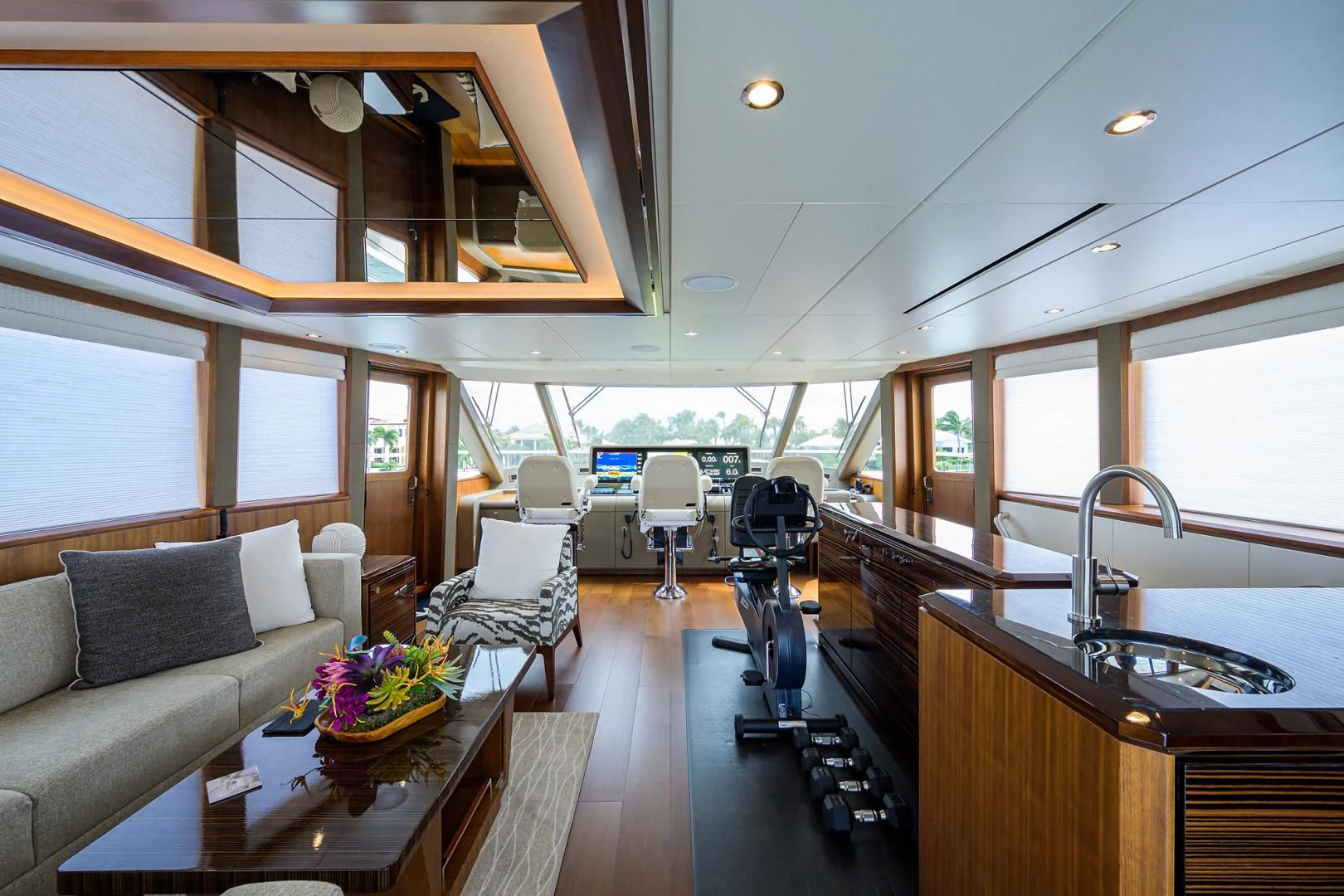 a room with a couch and a table and a large window aboard ZEPHYR Yacht for Charter