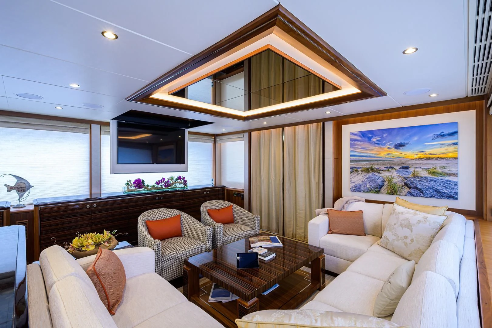 a living room with a large chandelier aboard ZEPHYR Yacht for Charter