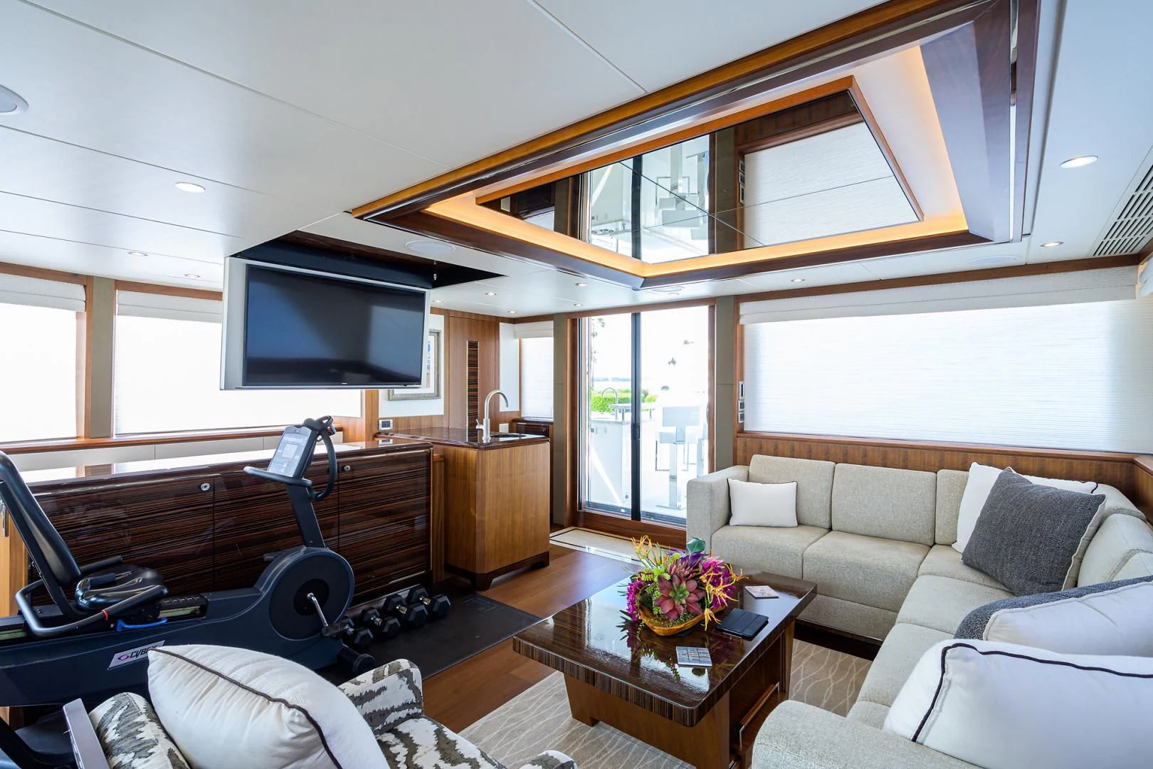 a living room with a couch and a television aboard ZEPHYR Yacht for Charter