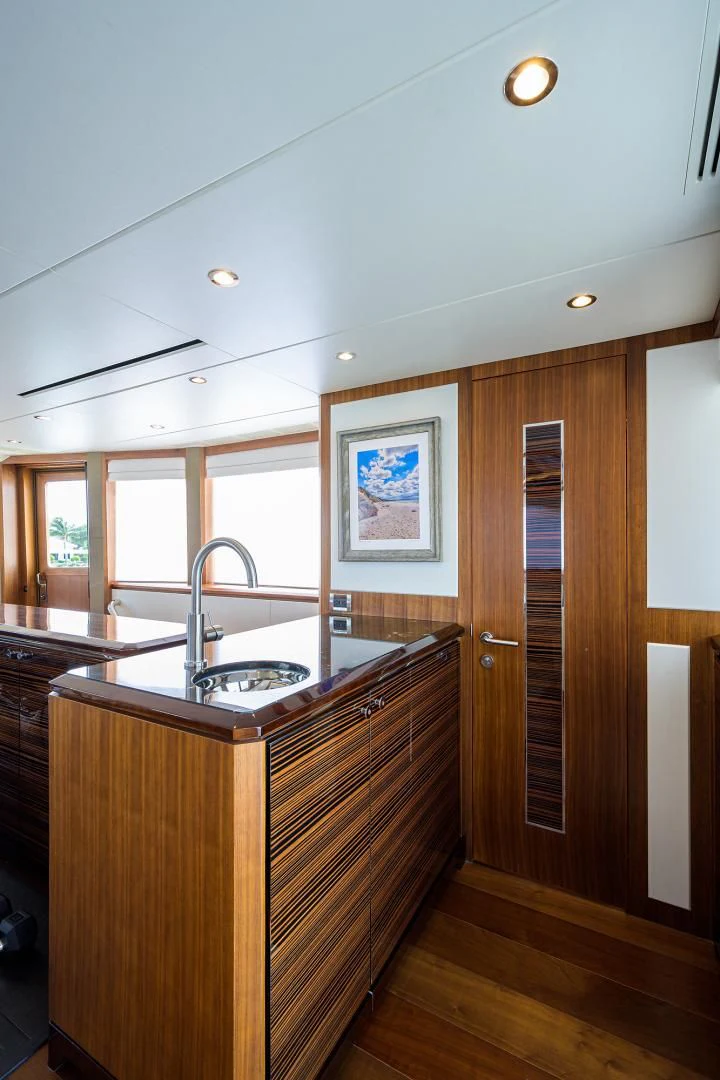 a kitchen with wooden cabinets aboard ZEPHYR Yacht for Charter