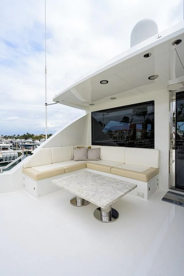 a white lounge chair on a white floor next to a window aboard ZEPHYR Yacht for Charter