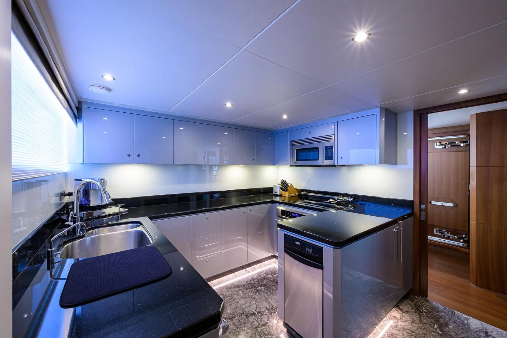 a kitchen with blue cabinets aboard ZEPHYR Yacht for Charter