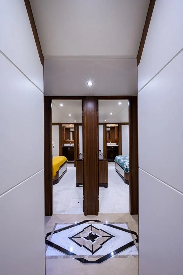 a hallway with a door and a bed aboard ZEPHYR Yacht for Charter