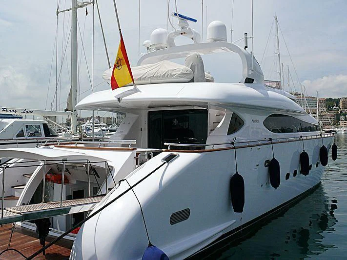 a white boat with a flag on it aboard SWEET DREAMS Yacht for Sale