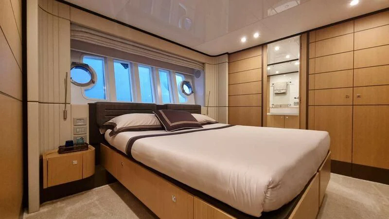 a room with a bed and a window aboard NENA Yacht for Sale