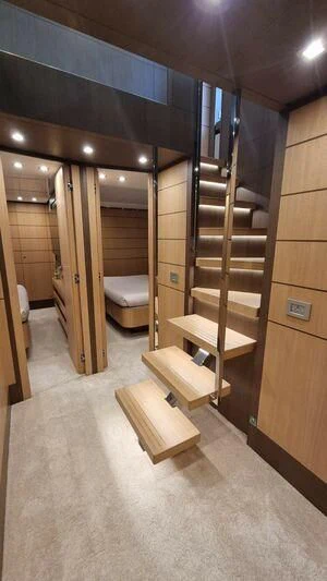 a wood staircase in a room aboard NENA Yacht for Sale
