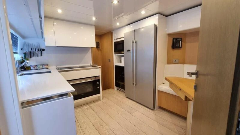 a kitchen with a refrigerator and a sink aboard NENA Yacht for Sale