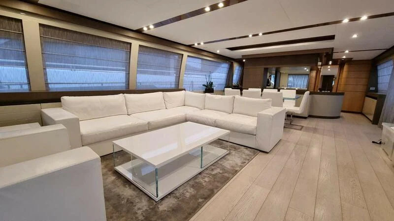 a large room with a table and couches aboard NENA Yacht for Sale