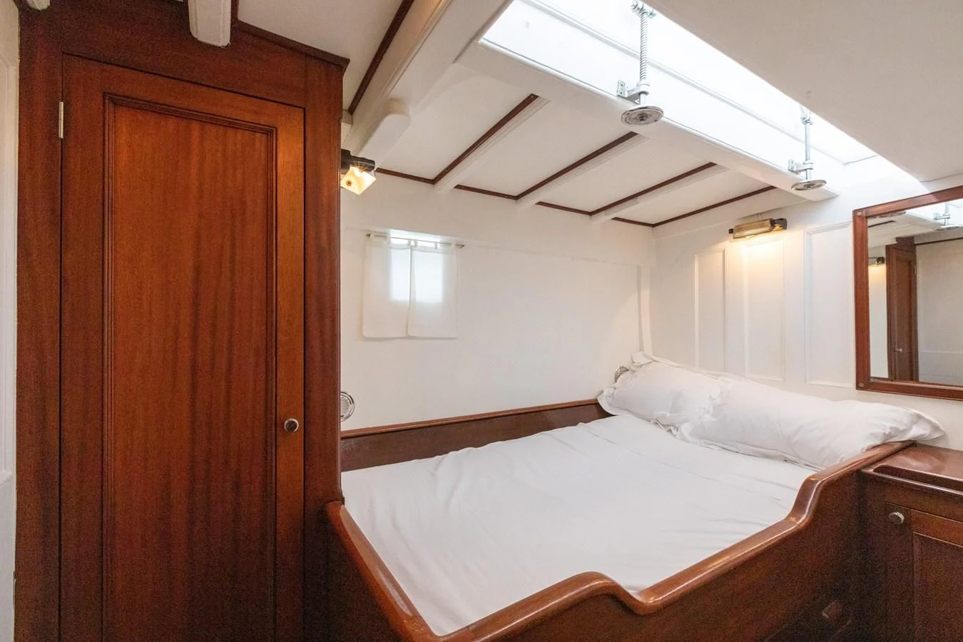 a room with a bed and a closet aboard MILENA Yacht for Sale