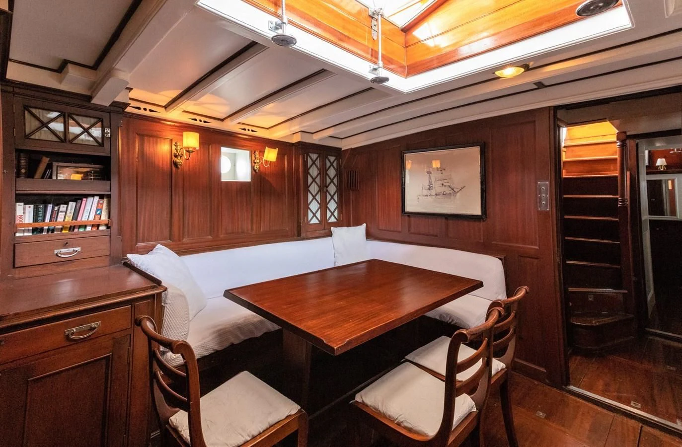 a room with a table and chairs aboard MILENA Yacht for Sale