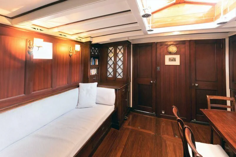 a room with a bed and a table aboard MILENA Yacht for Sale