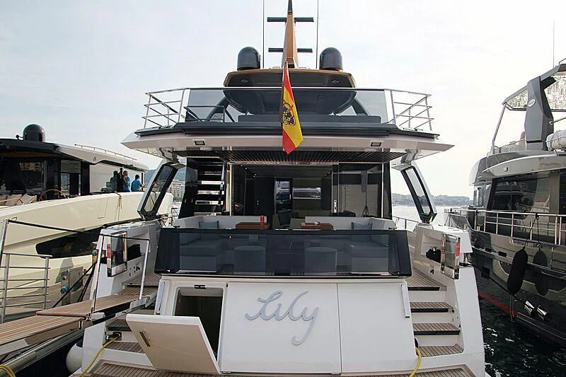 a boat with a flag on the front aboard LILY Yacht for Sale