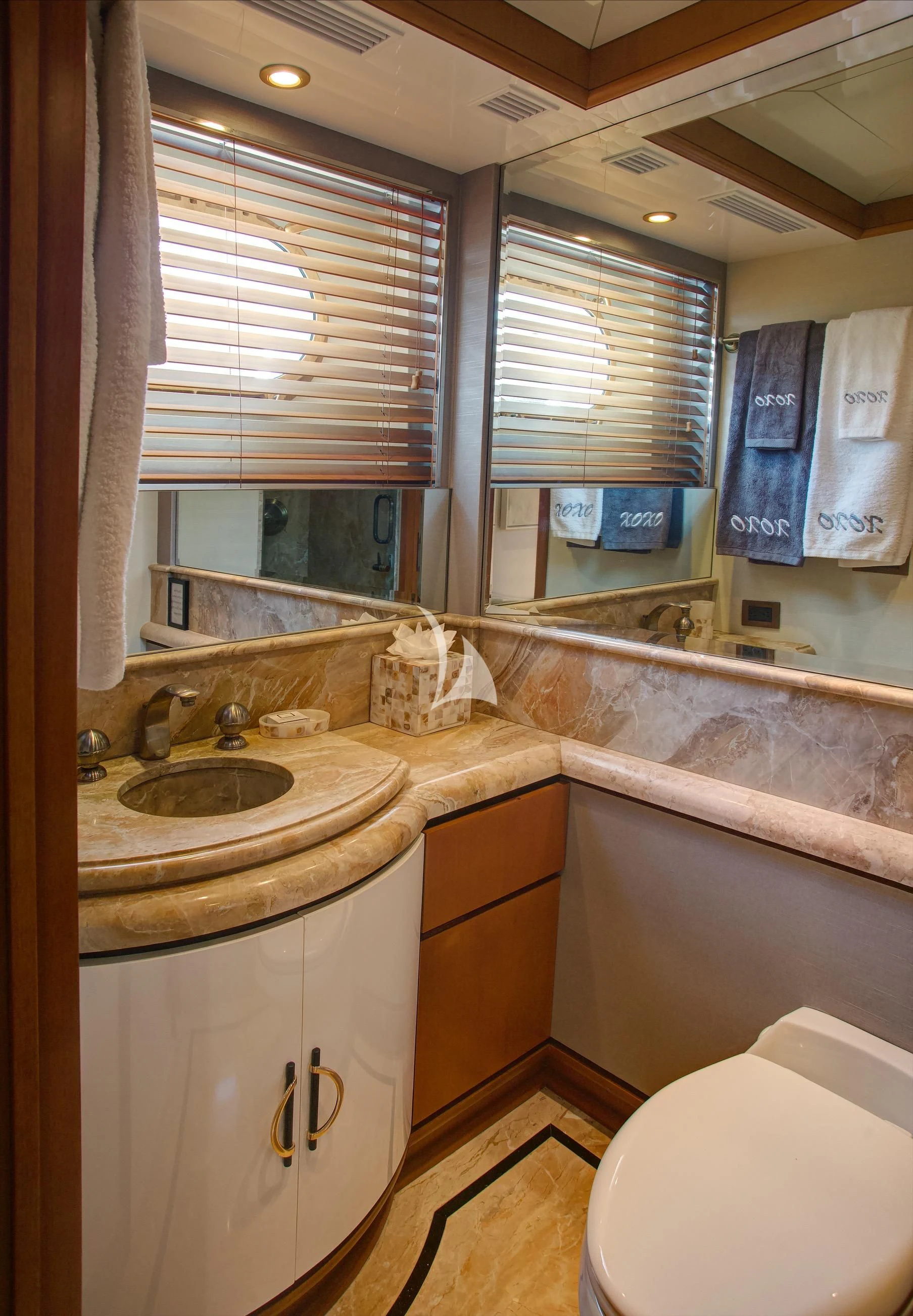 a bathroom with a sink and toilet aboard XOXO Yacht for Charter