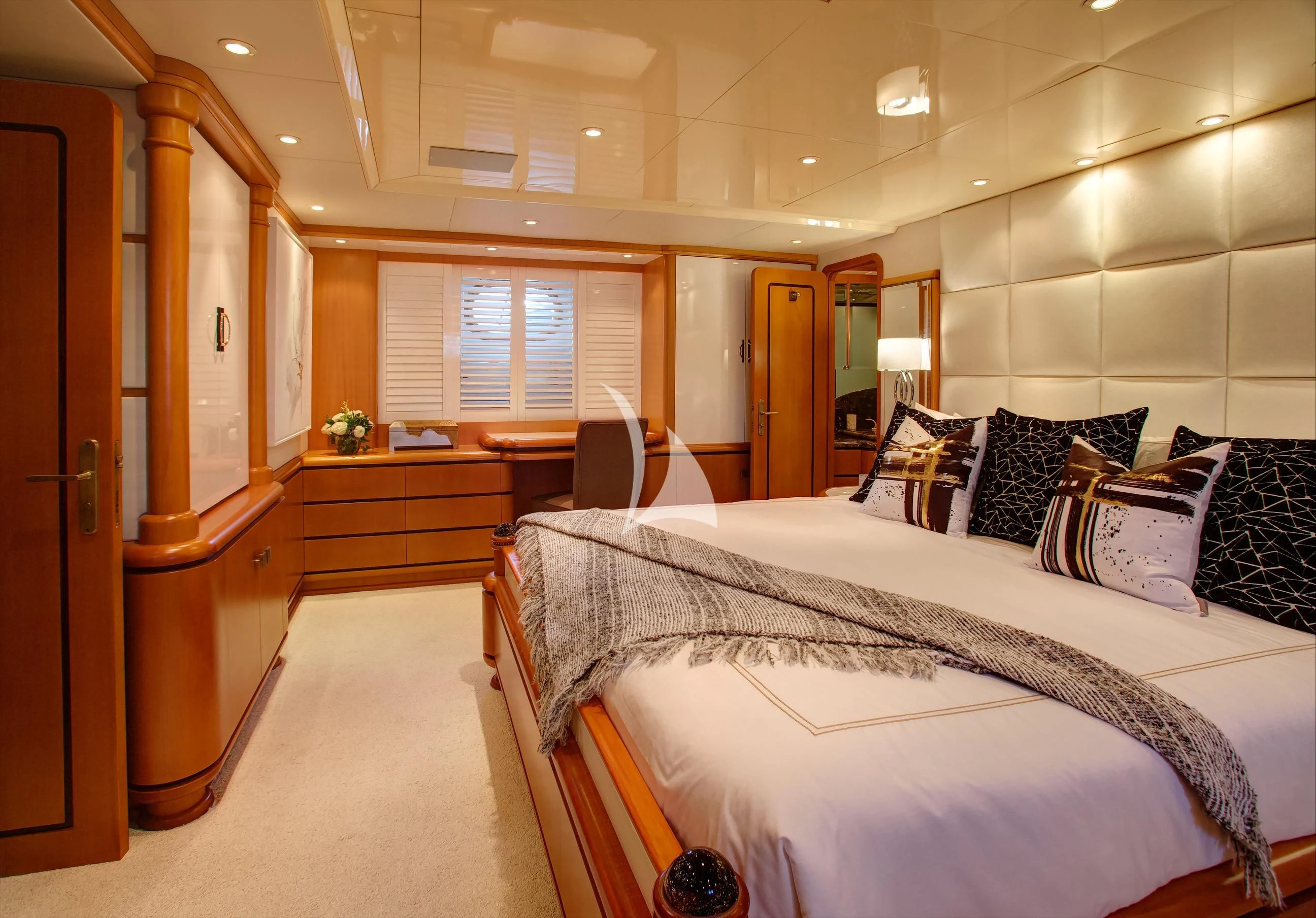 a bedroom with a large bed aboard XOXO Yacht for Charter