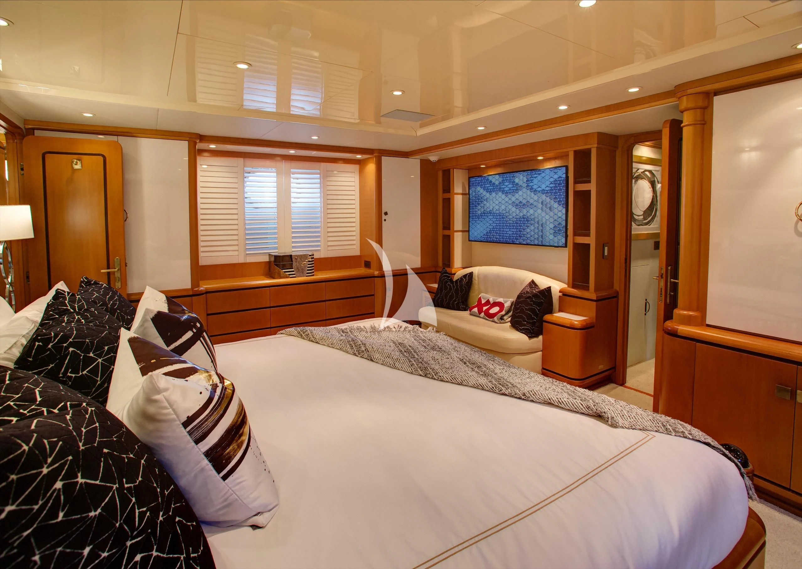 a bedroom with a bed and a couch aboard XOXO Yacht for Charter