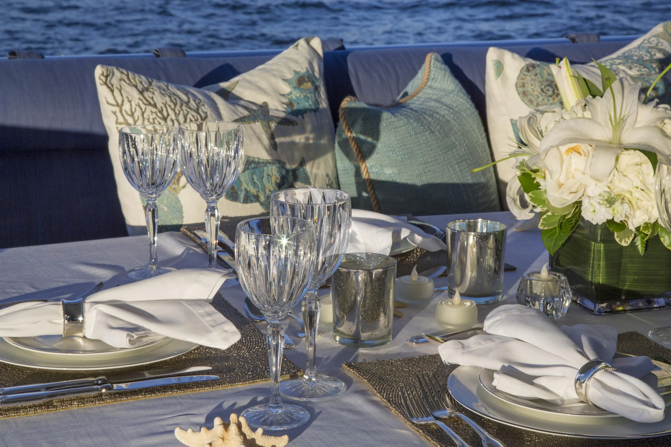 a table set with place settings aboard XOXO Yacht for Charter