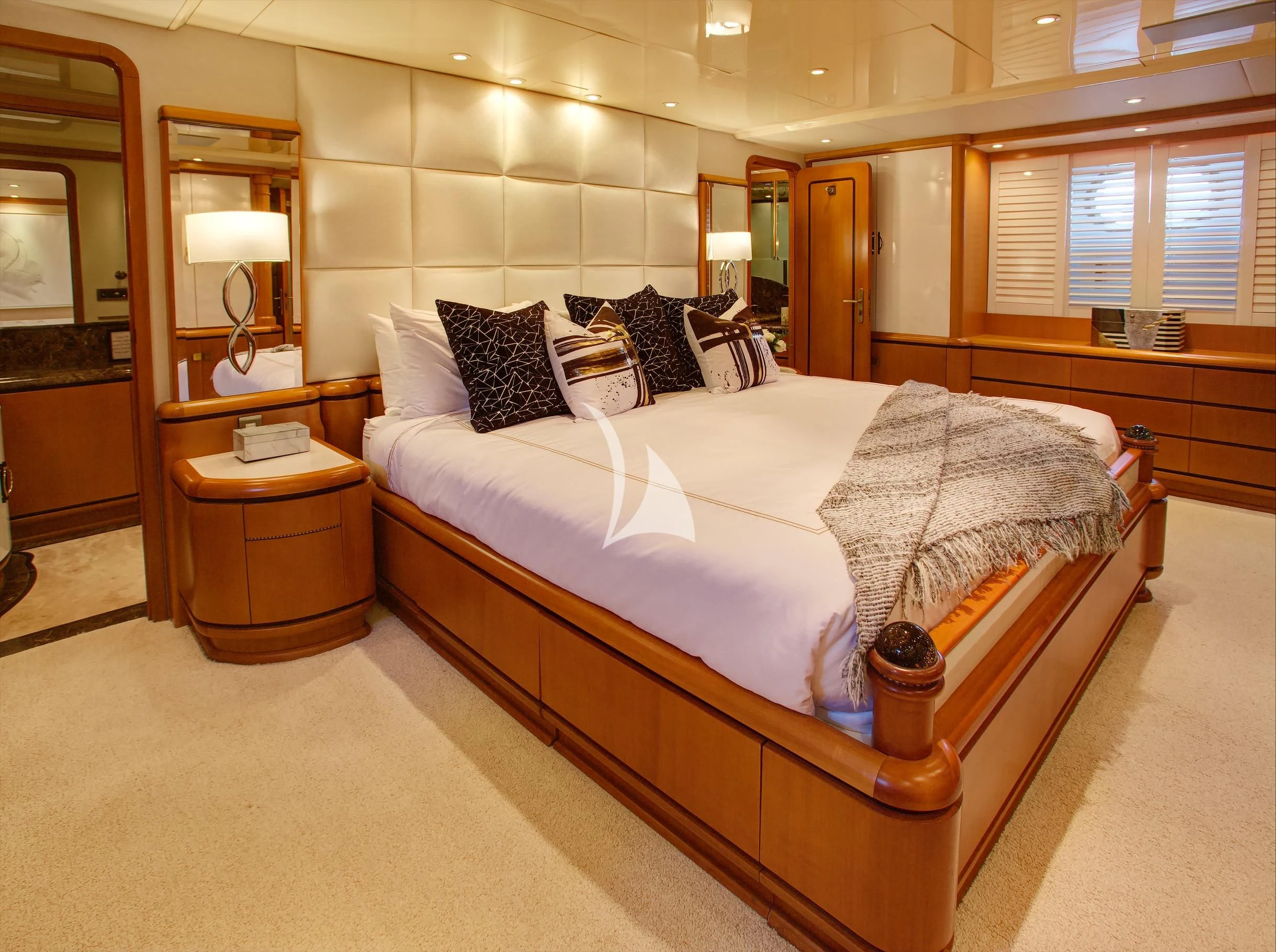 a large bed in a hotel room aboard XOXO Yacht for Charter