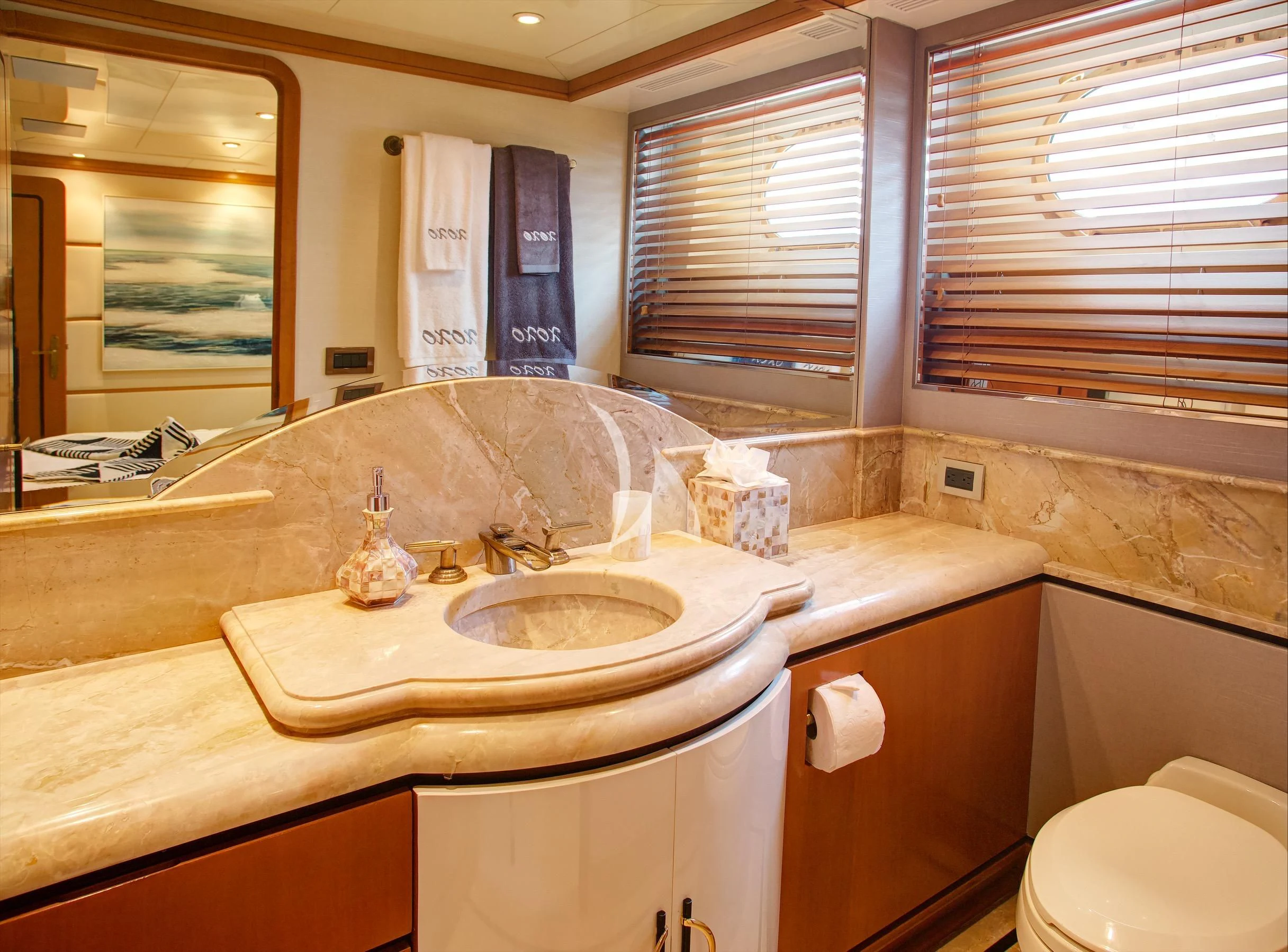 a bathroom with a sink and a toilet aboard XOXO Yacht for Charter