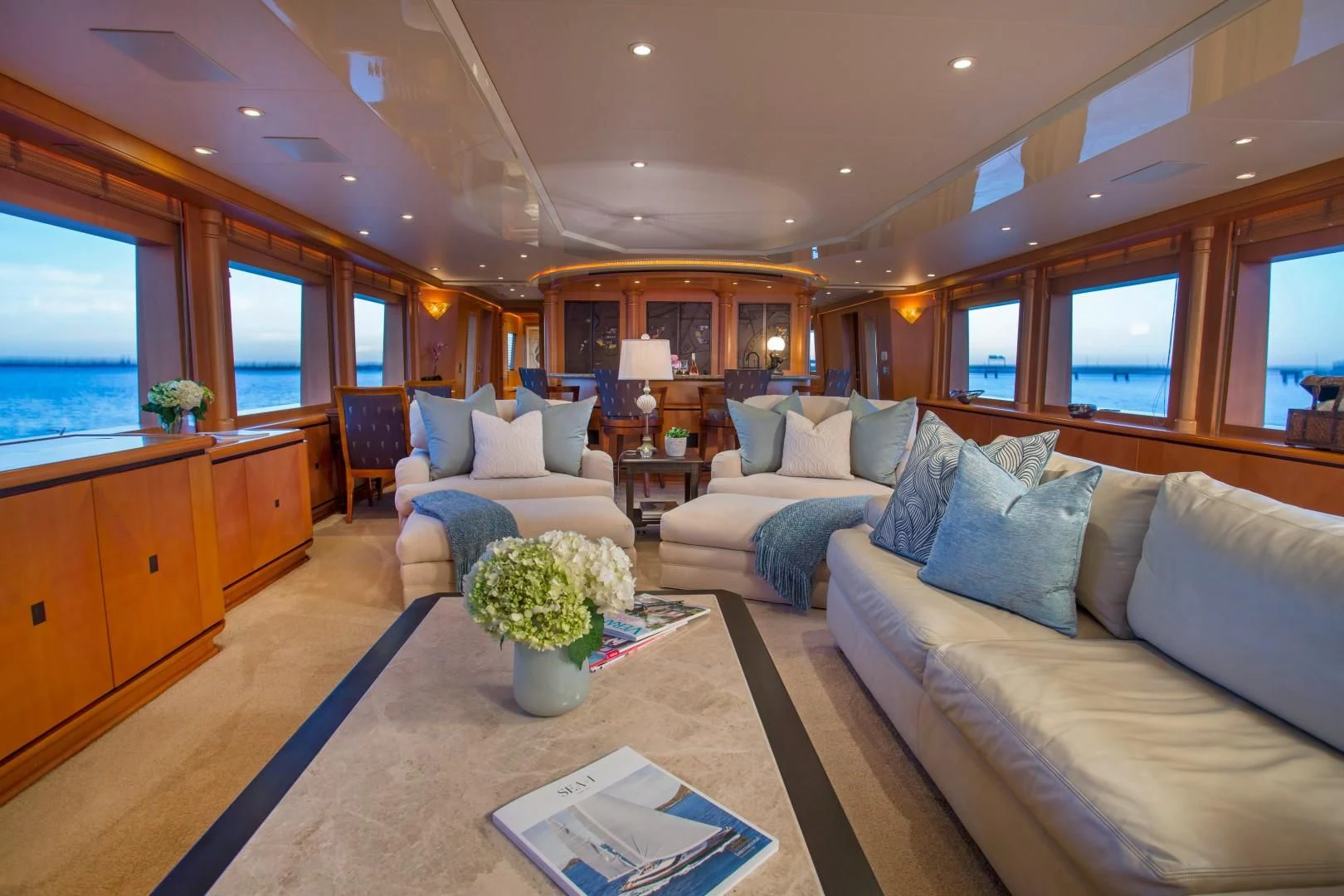 a living room with a couch and a coffee table aboard XOXO Yacht for Charter
