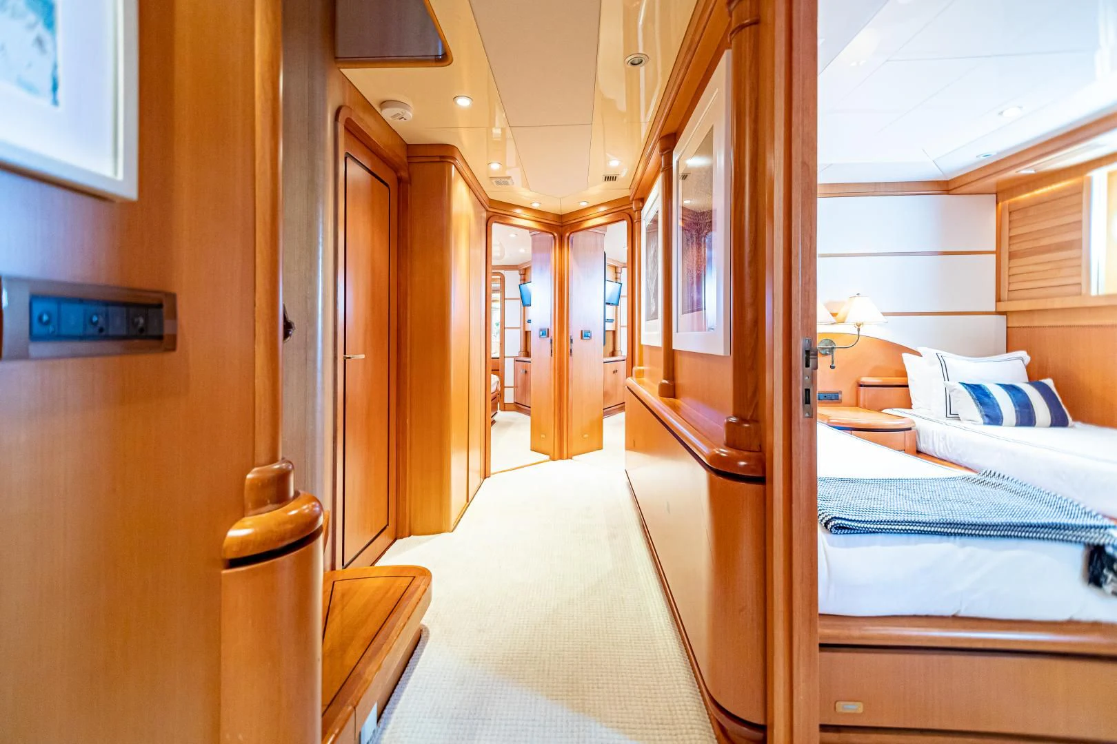 a room with a bed and a door aboard XOXO Yacht for Charter