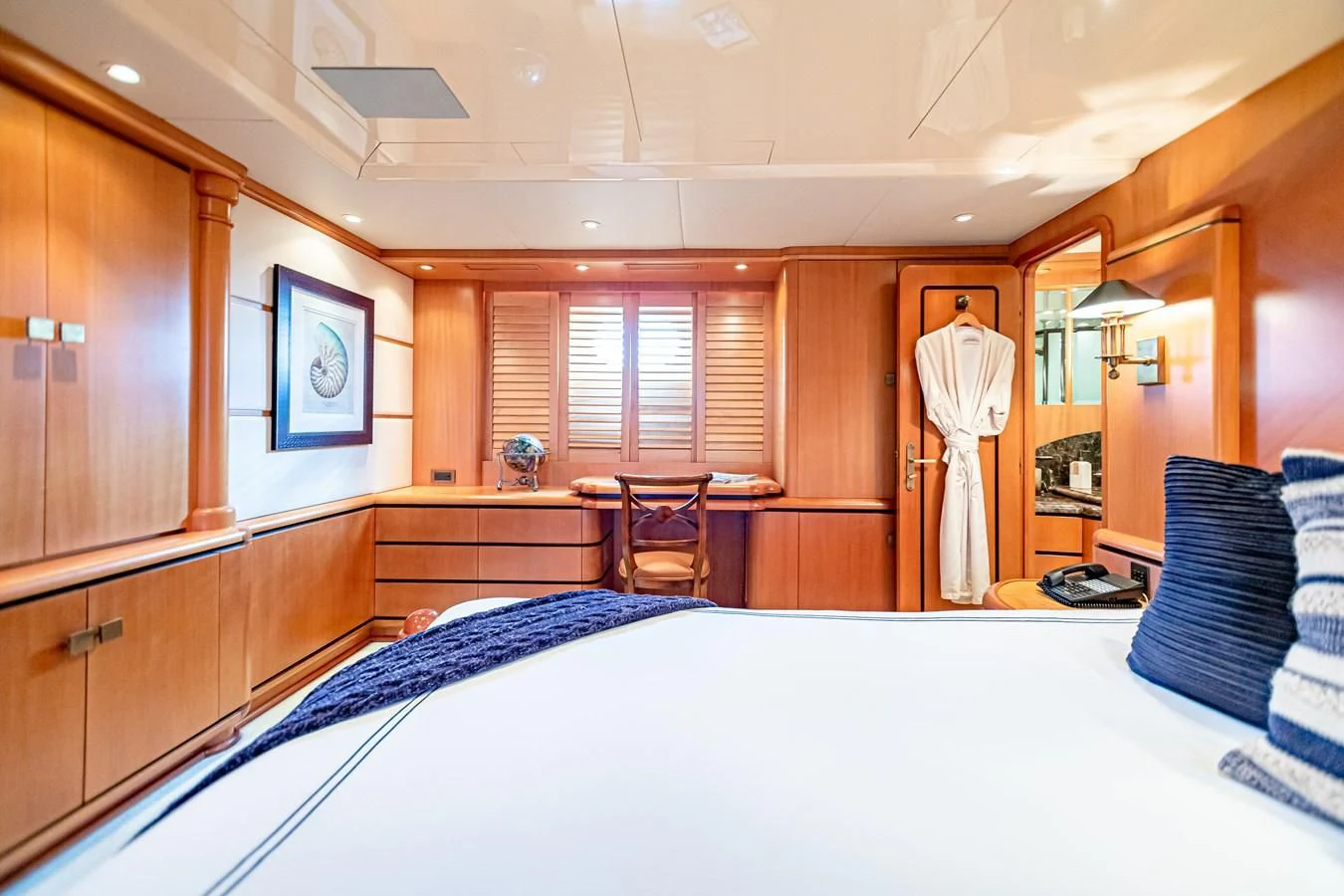 a room with a bed and a table aboard XOXO Yacht for Charter