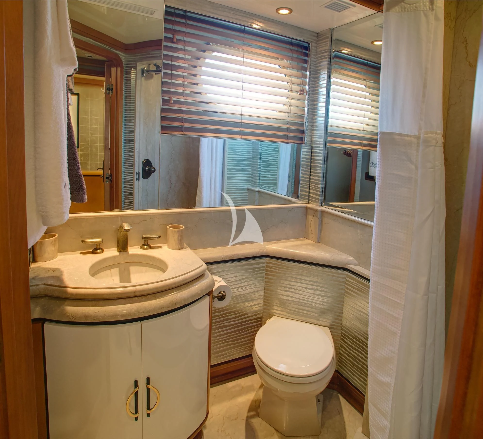 a bathroom with a sink toilet and a mirror aboard XOXO Yacht for Charter