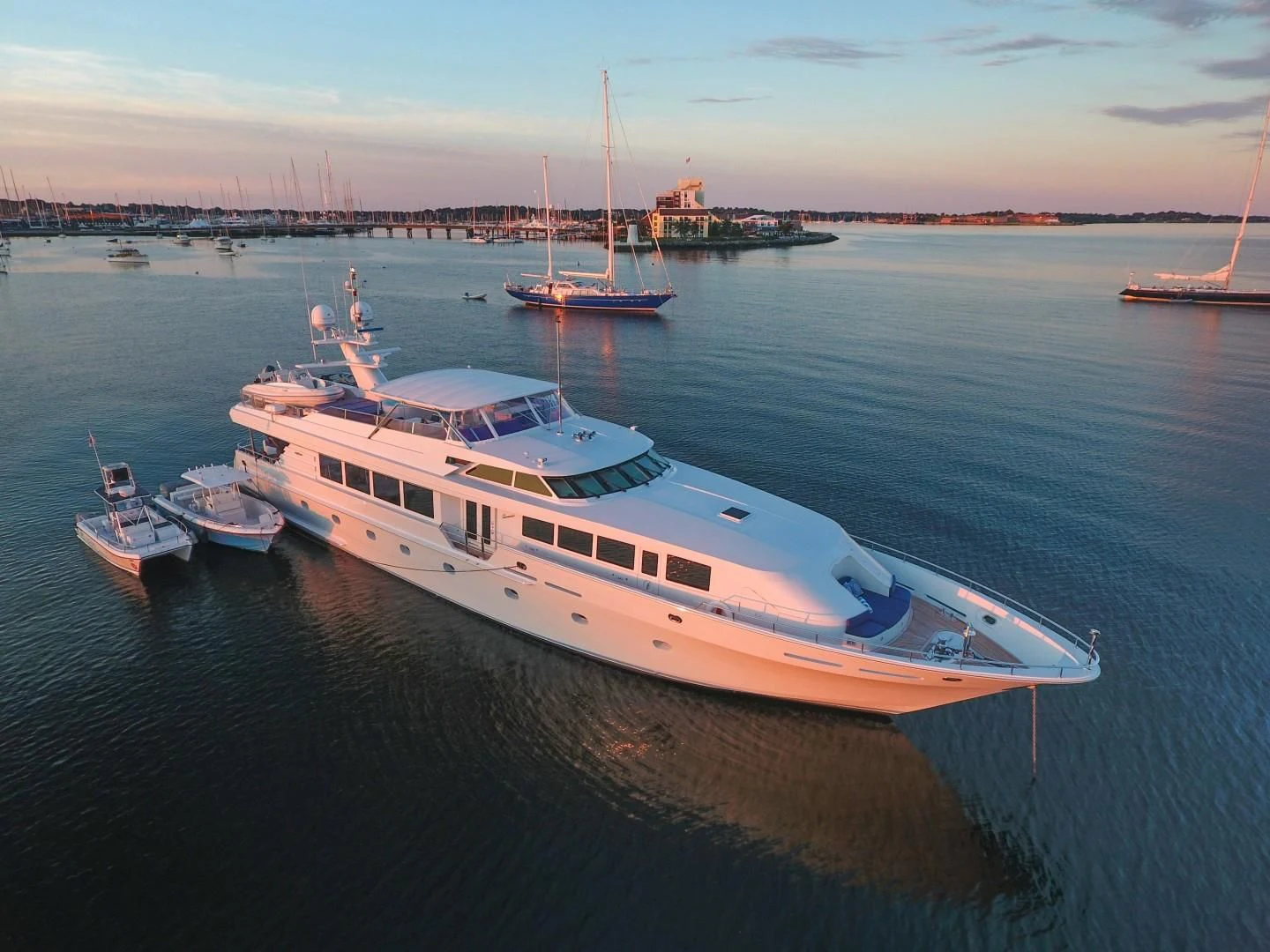 a large white boat sits in the water aboard XOXO Yacht for Charter