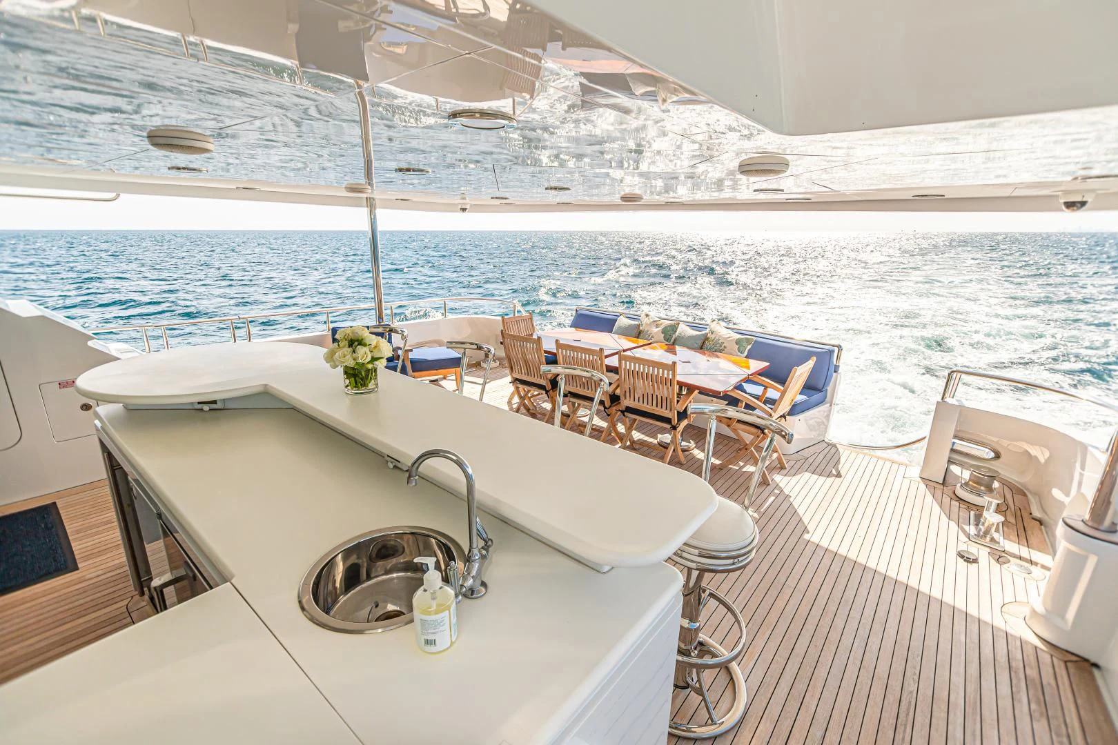 a table with chairs on it aboard XOXO Yacht for Charter