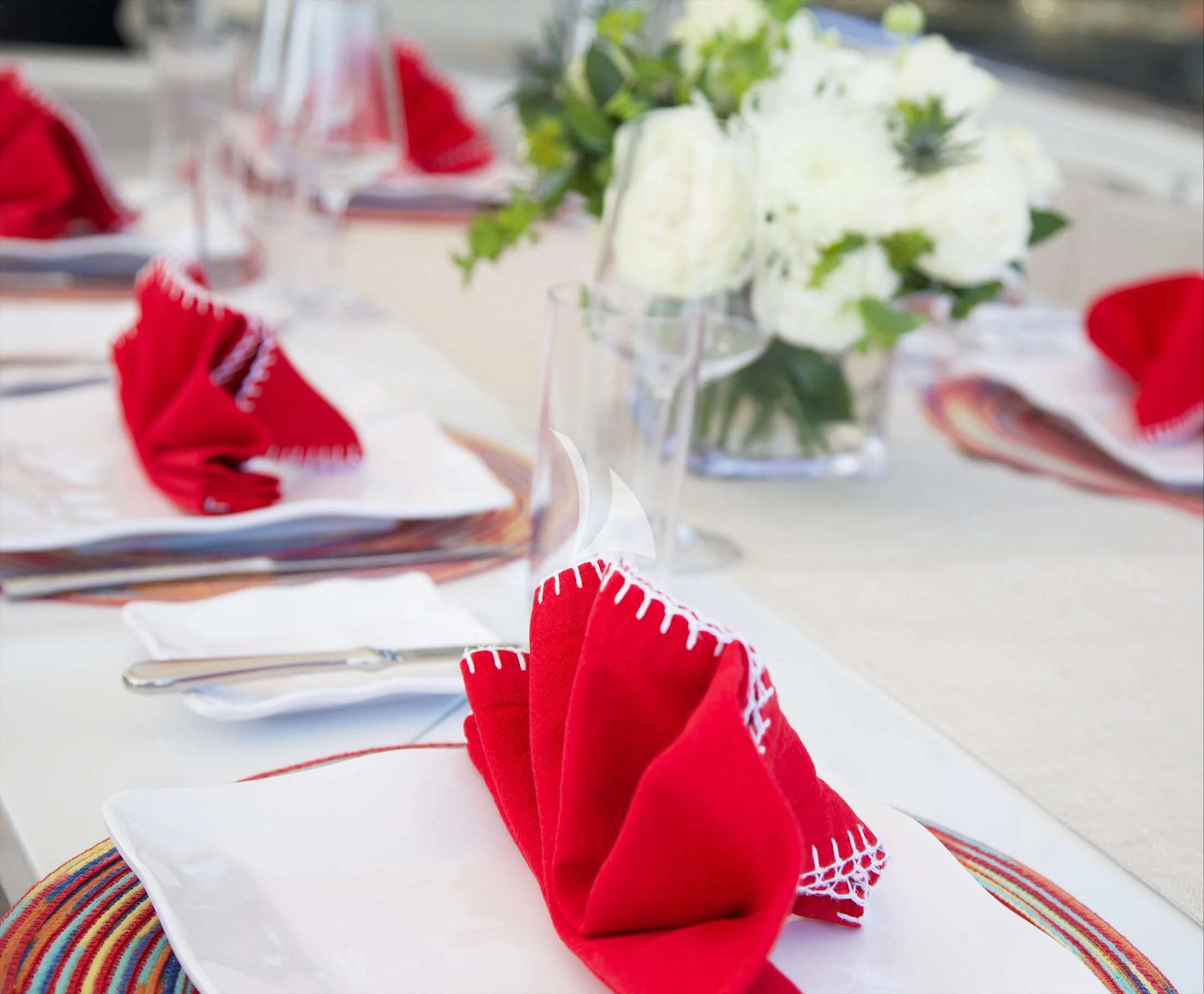 a table with napkins and flowers aboard XOXO Yacht for Charter