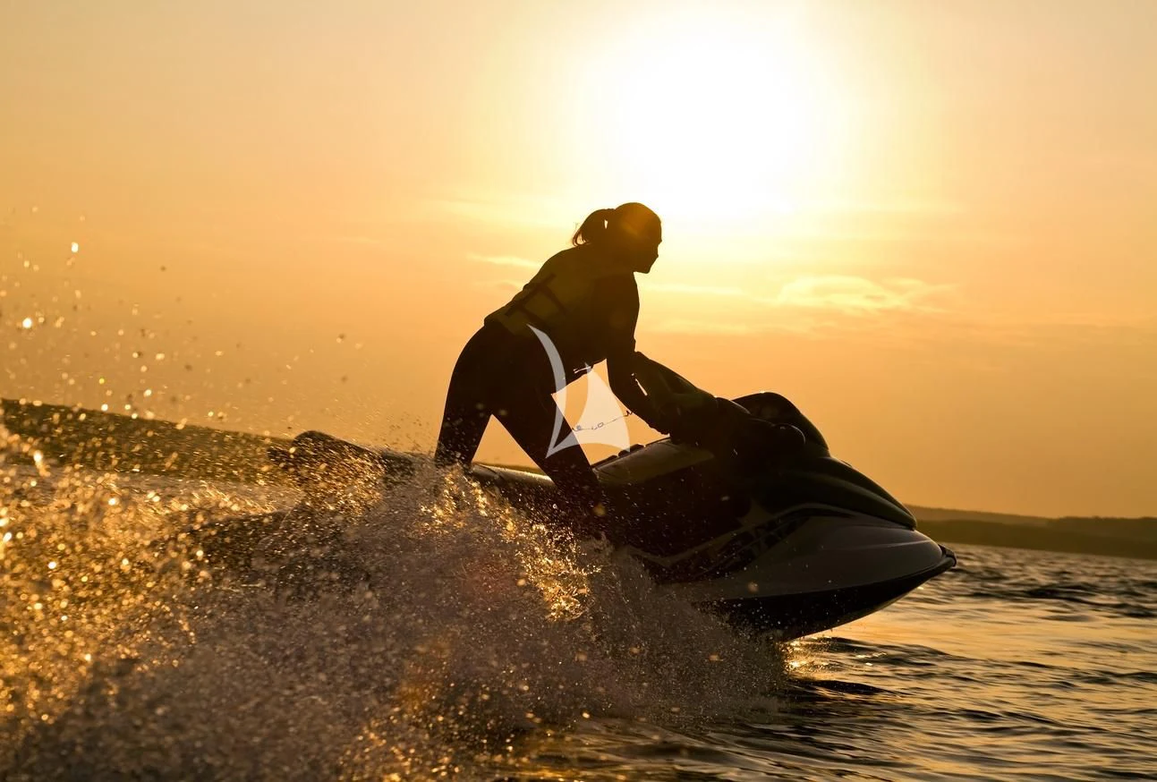 a man riding a surfboard aboard XOXO Yacht for Charter