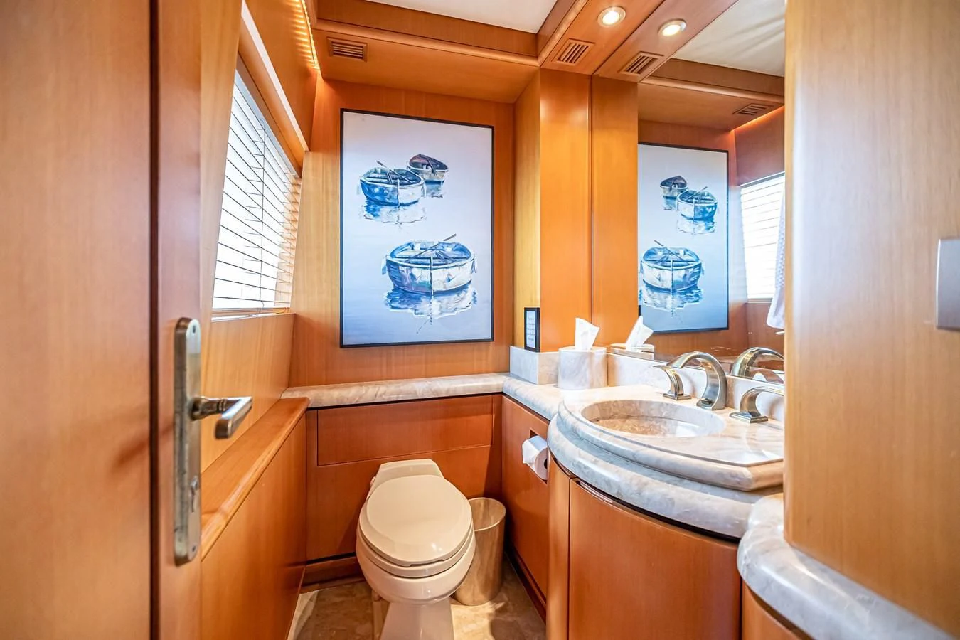 a bathroom with a sink and toilet aboard XOXO Yacht for Charter