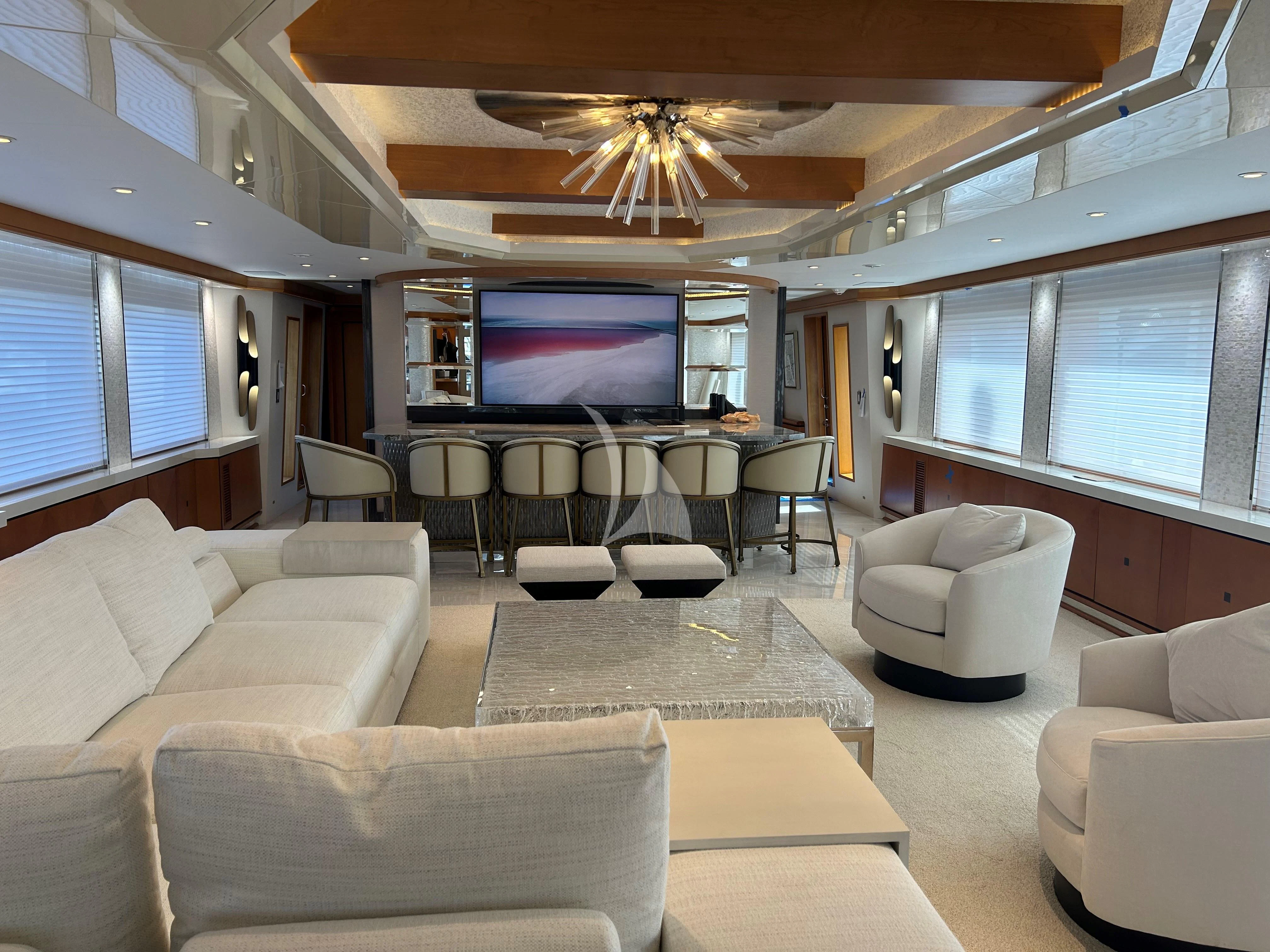 a living room with a large screen aboard XOXO Yacht for Charter