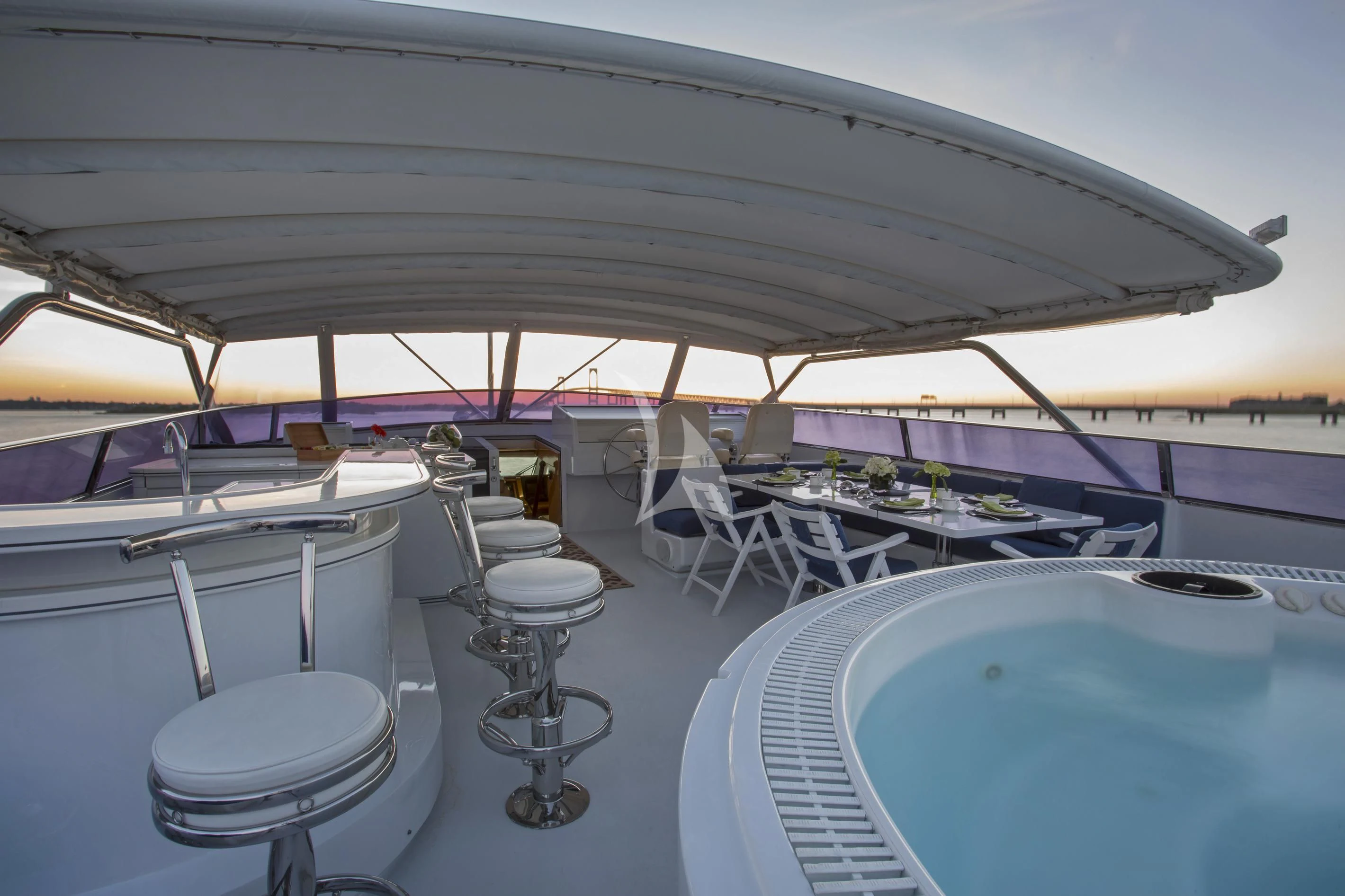 a large room with a pool table and chairs aboard XOXO Yacht for Charter