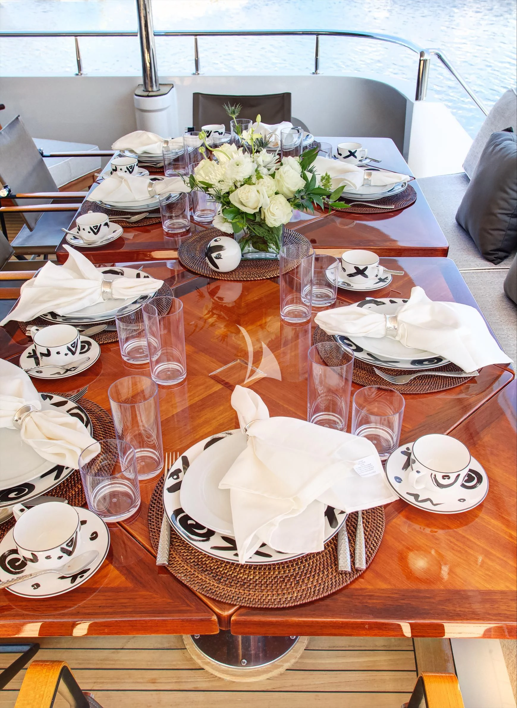 a table with plates and glasses aboard XOXO Yacht for Charter